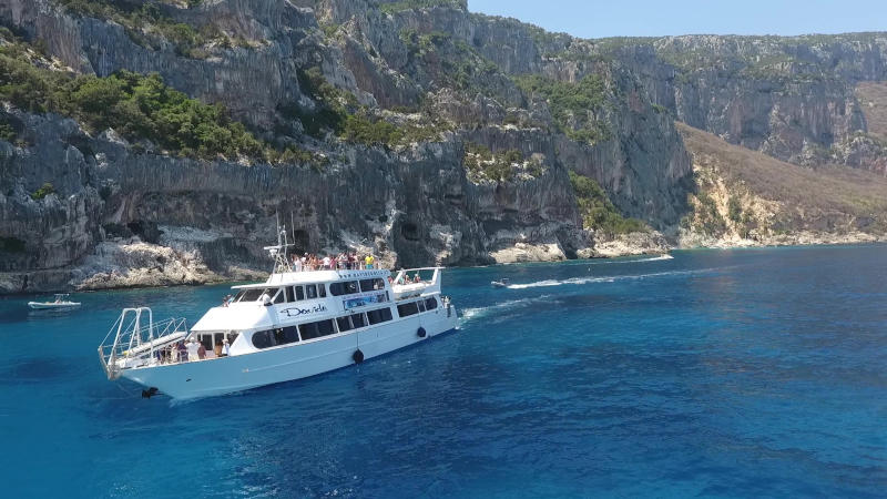 davide motor ship sailing along the coast of the Gulf of Orosei